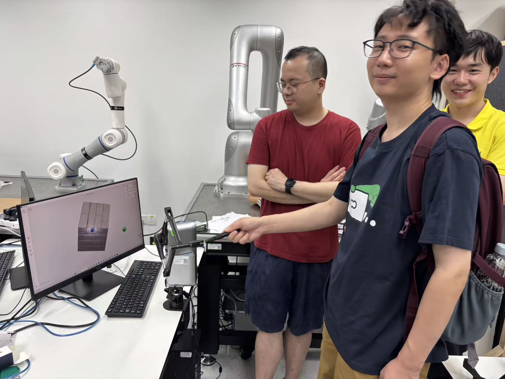 Workshop participants interact with an intelligent robotic system during the laboratory visit