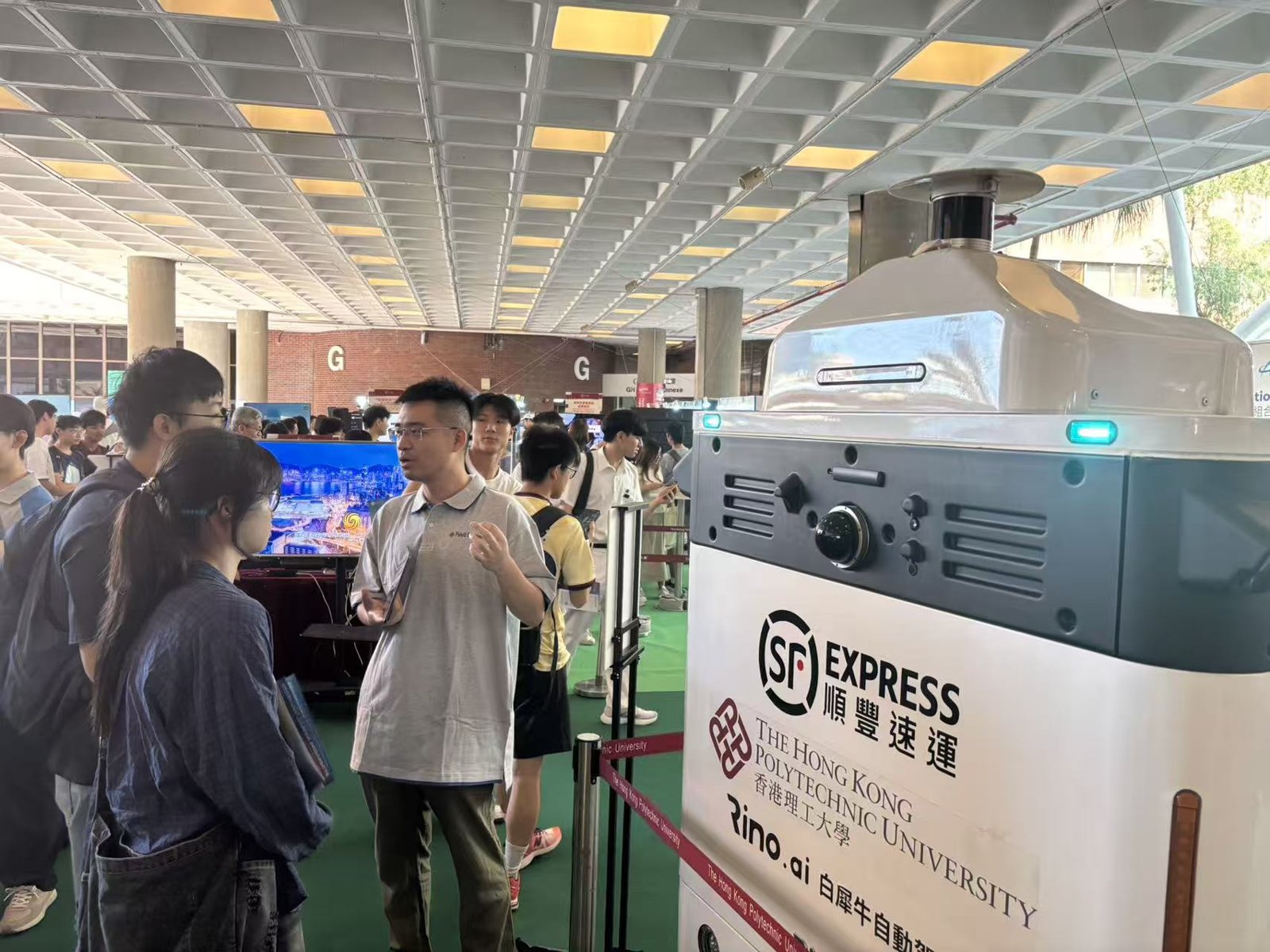 Visitors gathering around the autonomous delivery vehicle